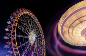 swing ride in motion in the background big wheel, long time exposure swing ride in motion in the background big wheel, long time exposure